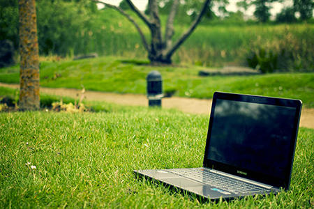 Notebook Computer sitting in the grass